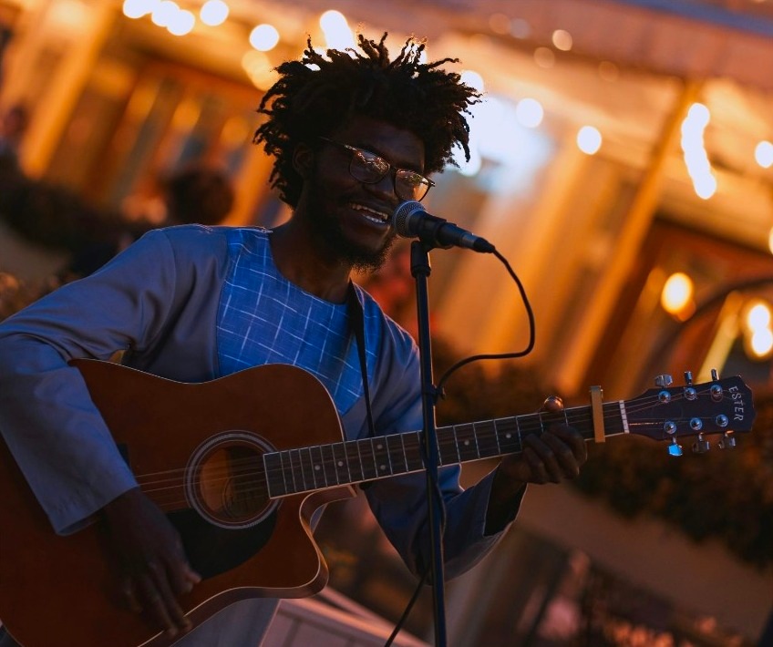 Singer with an acoustic guitar on stage